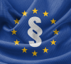 Flagge der Europäischen Union mit einem Paragrafen-Symbol in der Mitte.